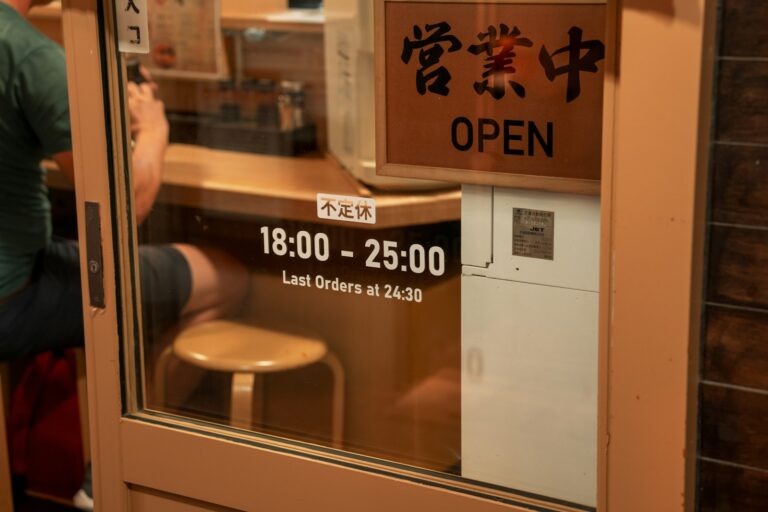 A man standing in front of a counter in a restaurant